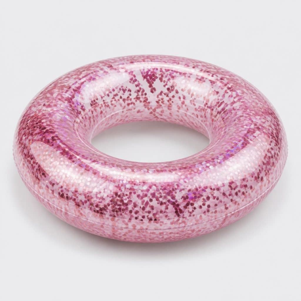 Bouée gonflable ronde à effet paillettes posée sur fond clair