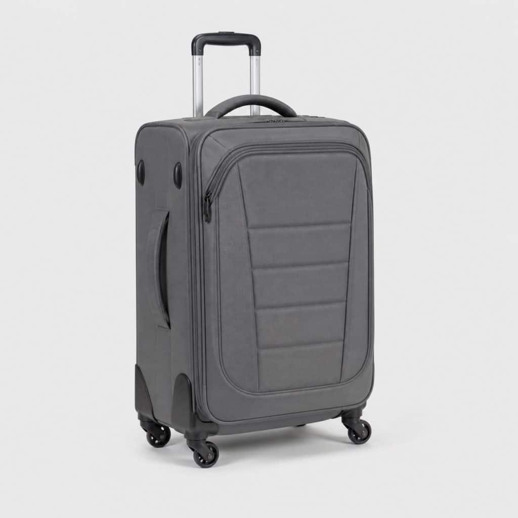 Sac de voyage trolley gris à base semi-rigide sur fond clair